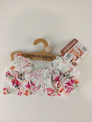 a close up of a white bra top with pink flowers on it