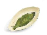 a small bowl with a green leaf inside of it