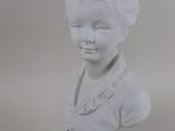 white marble bust of a young boy with a black base