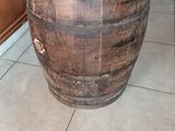 a table made out of a wine barrel with a wine glass on top