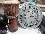 a clock that is sitting on a table next to other items