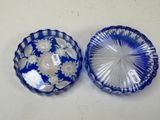 two blue and white glass dishes on a white table