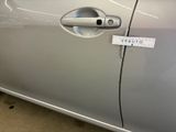 a silver car with a sticker on it ' s door handle