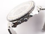a close up of a watch on a white surface