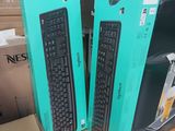 two keyboards and a mouse in a box on a table