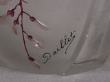 a close up of a glass vase with a flower on it
