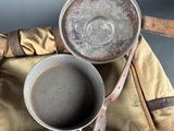 a pot and pan sitting on a bag next to a knife