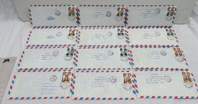 envelopes with stamps and envelopes are laid out on a table