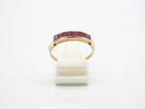 a close up of a gold ring with a ruby stone in it