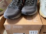 several pairs of running shoes are on a box in a store