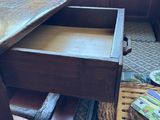 a wooden table with a drawer on top of it