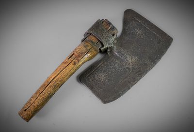 a close up of an old axe with a wooden handle