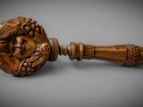 a close up of a wooden door handle on a gray surface