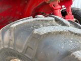 a close up view of a tractor tire with a red cover