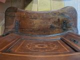 a wooden bench that is sitting in the corner of a room