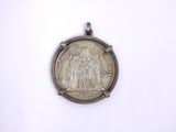 a silver coin with a picture of a man on it