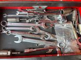many wrenches in a red box on the table