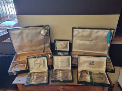 a lot of silverware on a table in a room