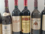 several bottles of wine are lined up in a row on a table