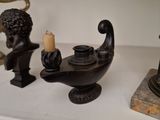three candles that are sitting on a shelf