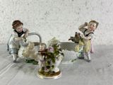 two figurines that are sitting on a table