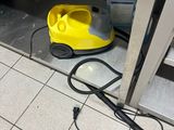 a yellow vacuum cleaner sitting on the floor next to a door