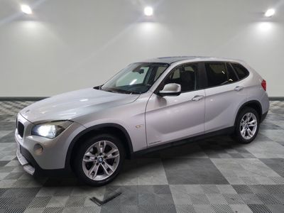 a picture of a silver bmw suv parked in a garage