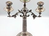 a silver candelab with three candles on it