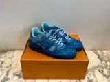 a pair of blue sneakers sitting on top of a box