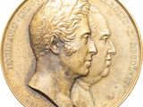 une image montrant un gros plan d'une médaille d'or à deux têtes