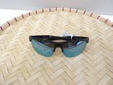 a pair of sunglasses sitting on top of a woven basket