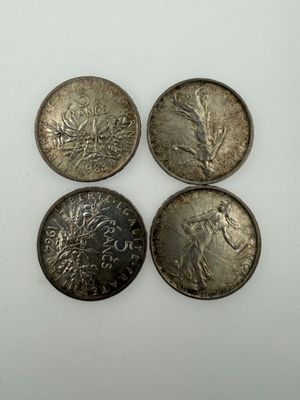three silver coins, one of which is a woman and one of which is a man