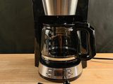 a coffee maker that is sitting on a wooden table