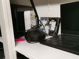 a laptop computer sitting on a shelf in a room