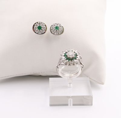 pair of emerald and diamond earrings and ring on a white pillow
