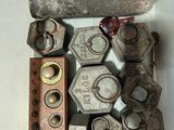 many nuts and bolts in a container on a table