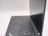 a laptop computer sitting on a white surface with a black keyboard