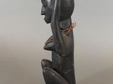 a close up of a sculpture of a person holding a bowl