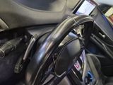 a steering wheel with a cell phone attached to it