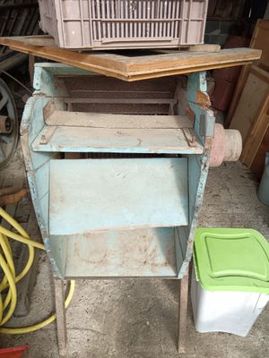 a picture of an old washer with a basket on top of it