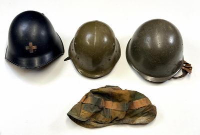 three helmets and a hat are sitting on a white surface