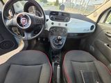 the interior of a small car with red trims and a steering wheel