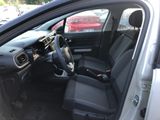 the interior of a car with the door open and the driver ' s seat down