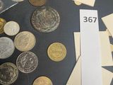 a lot of coins on the table and a pen on the table