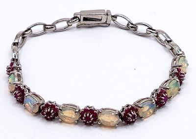 a close up of a bracelet on a white surface
