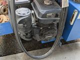 an image of a blue machine with a hose attached to it