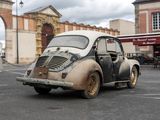 an old car that is parked in a parking lot