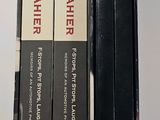 three books that are sitting next to each other on a table
