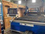 a large machine that is cutting wood in a factory
