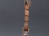 an old metal helmet with a metal strap hanging from it ' s side